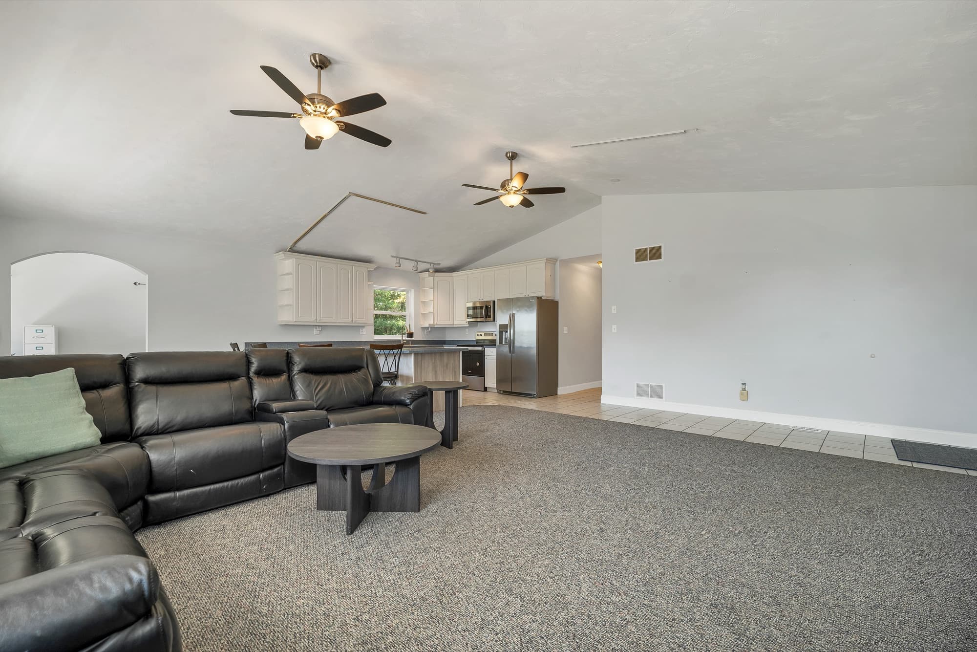 The family room looking toward the kitchen, with the sectional and the peninsula seating
